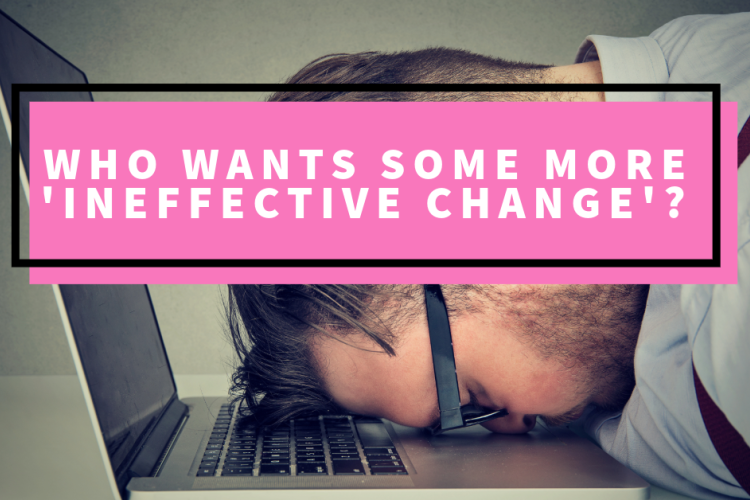 A frustrated man banging his head on his open lap top.